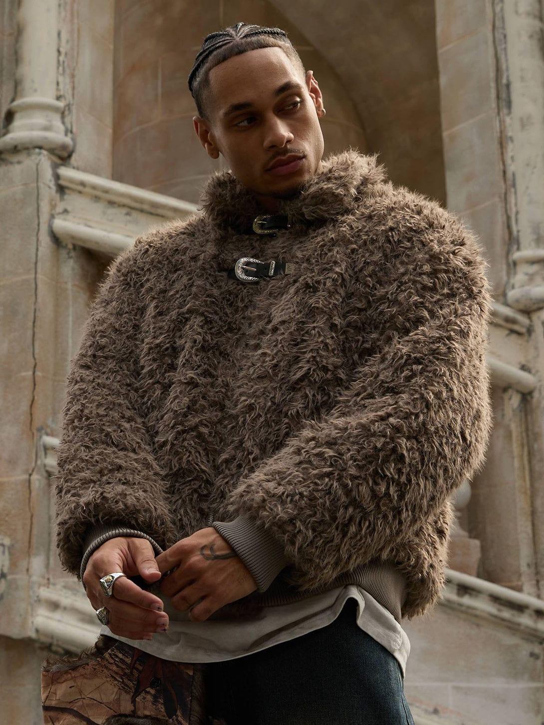 Model in a textured faux fur jacket with leather buckles, styled by TALISHKO.
