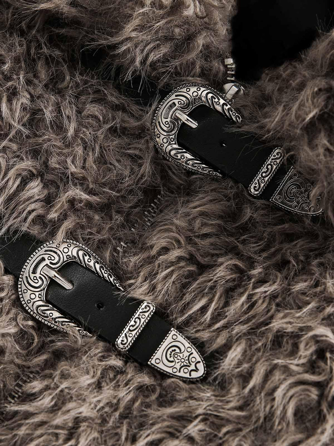 Intricate metal leather buckles on textured faux fur, showcasing TALISHKO's unique design.
