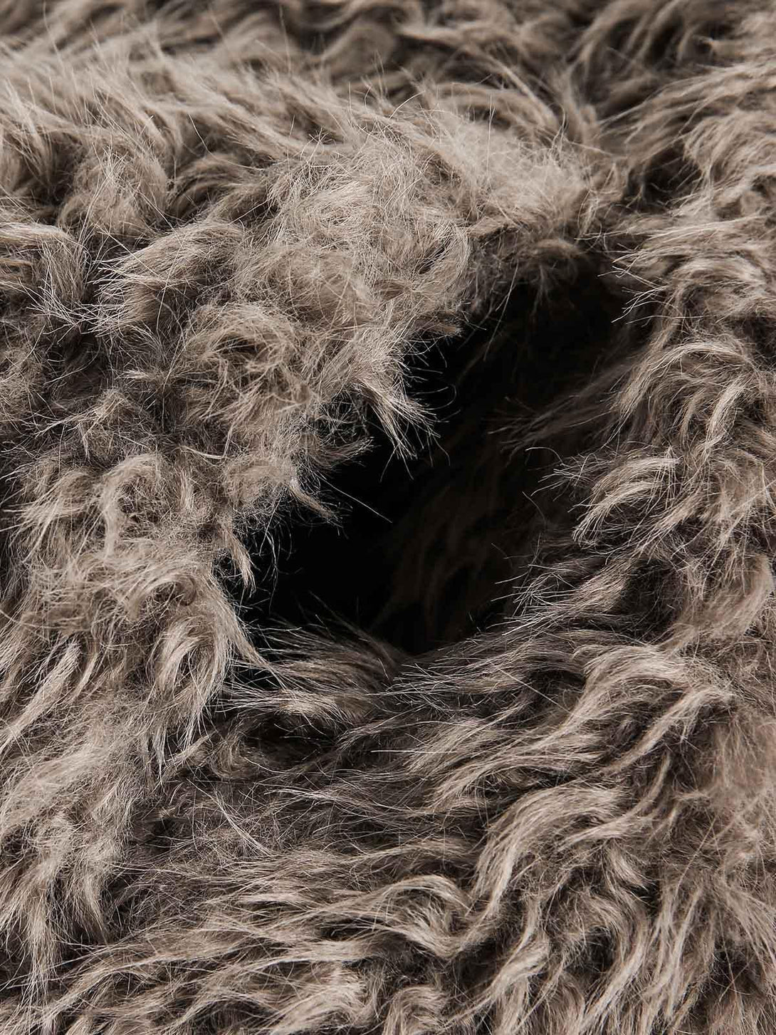 Zoomed-in texture of plush faux fur by TALISHKO, highlighting its rich and cozy design.