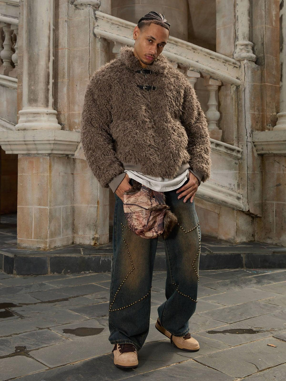 Model showcasing a cozy faux fur jacket with leather buckles, designed by TALISHKO.