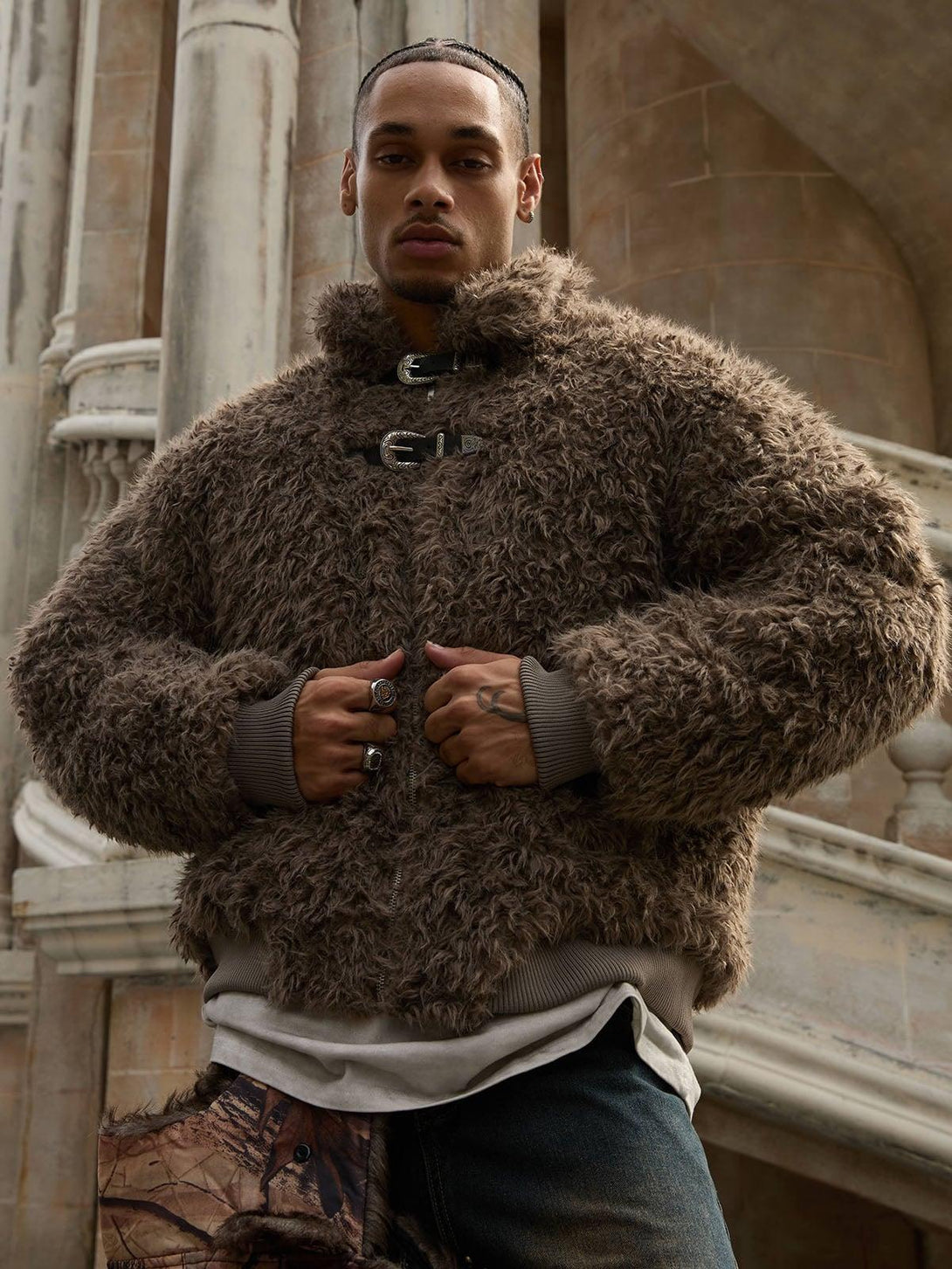 Model wearing a brown faux fur jacket with metal leather buttons, crafted by TALISHKO.
