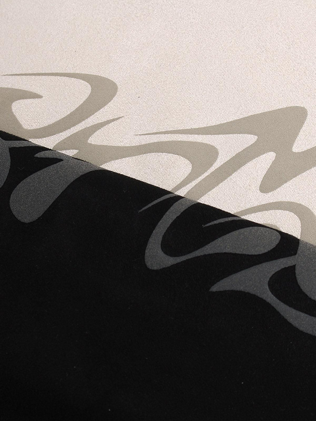 Intricate look at TALISHKO's metallic print on suede fabric, highlighting unique texture.