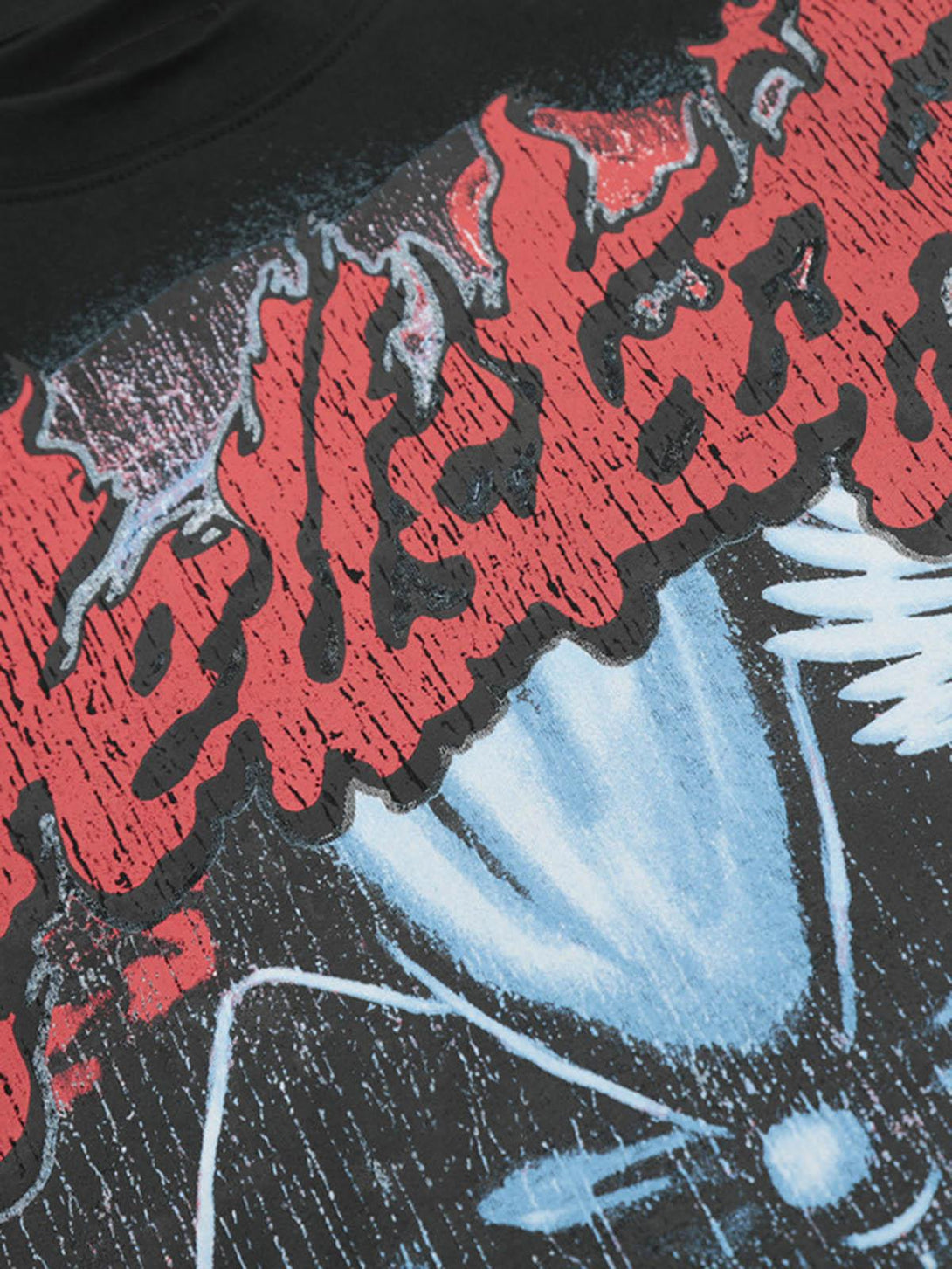 A close-up of the TALISHKO T-shirt, highlighting its bold red and blue graphic design details.