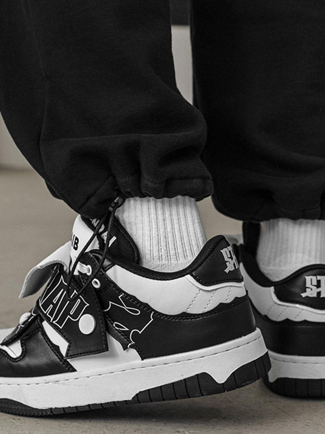 TALISHKO skate shoes in black and white, featuring unique color blocking and graphic details.