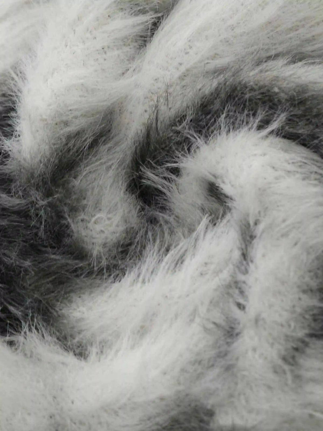 Zoomed-in texture of TALISHKO's mohair sweater, highlighting its unique black and gray pattern.