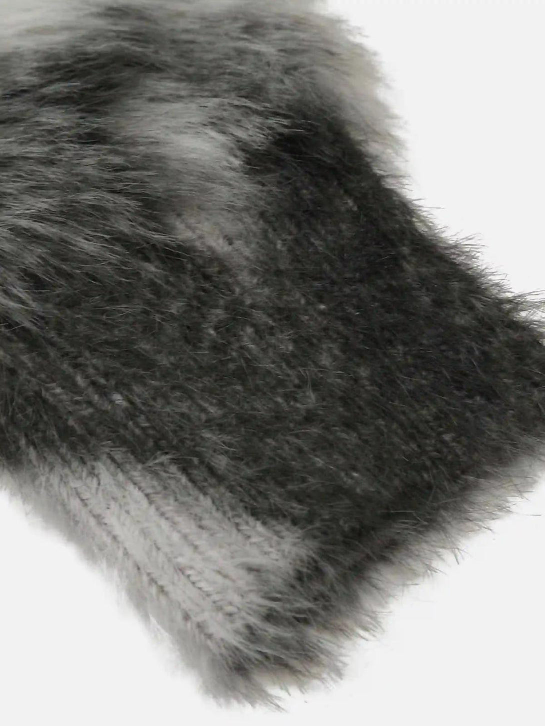 A close-up of TALISHKO's mohair sweater texture, showcasing its unique black and gray pattern.