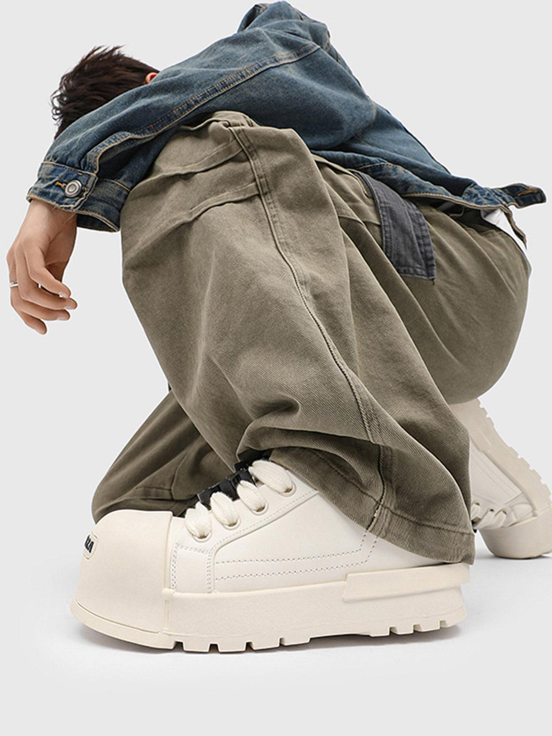 TALISHKO's monochrome chunky tread sneakers styled with oversized khaki pants and denim jacket.