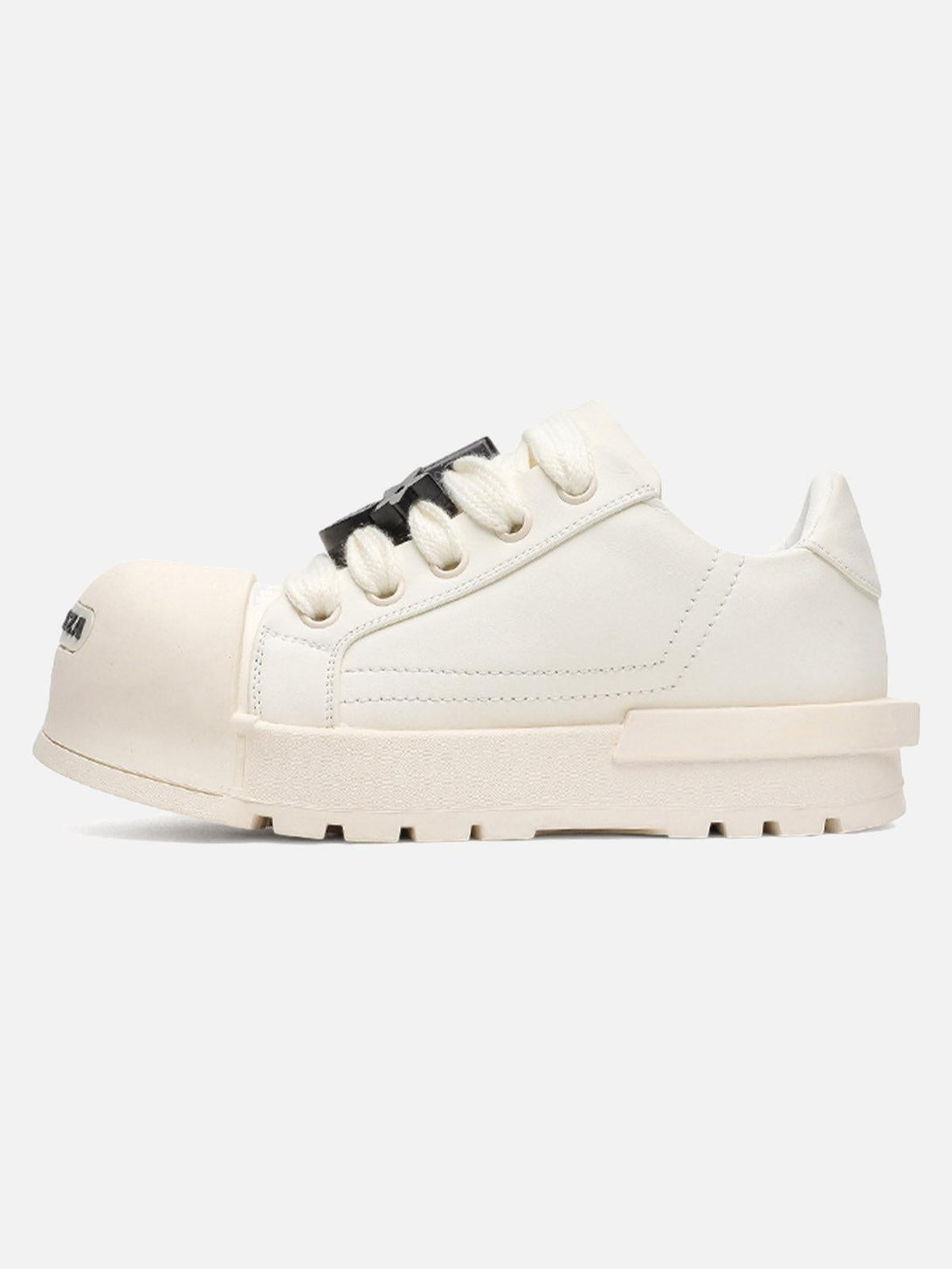 Side view of white chunky tread sneakers by TALISHKO, showcasing bold laces and unique design.
