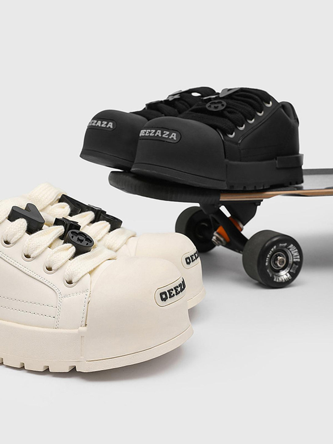 TALISHKO's monochrome chunky tread sneakers in black and white on a skateboard for a stylish vibe.