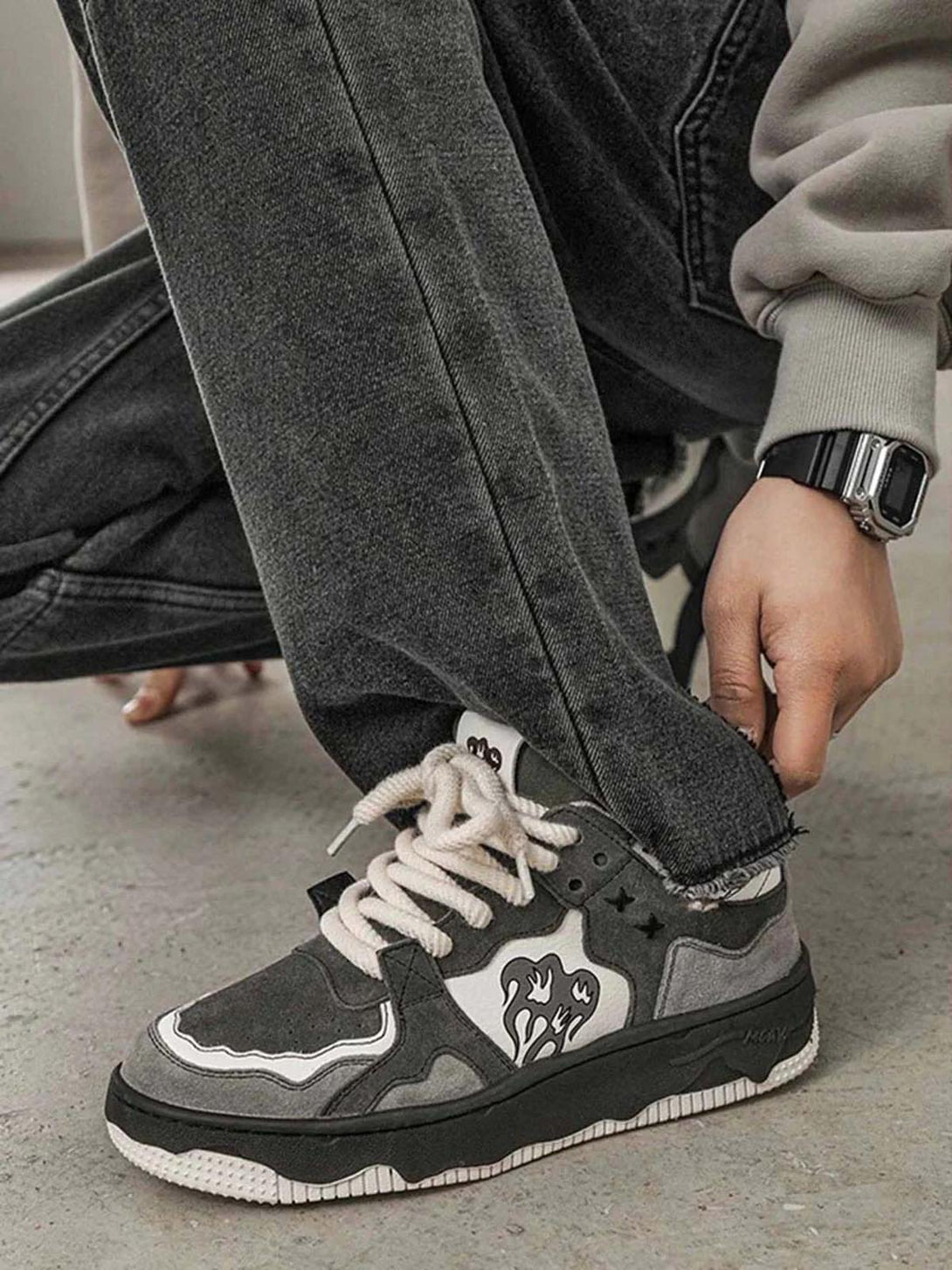 A close-up of TALISHKO sneakers paired with dark jeans, highlighting their street-style design.