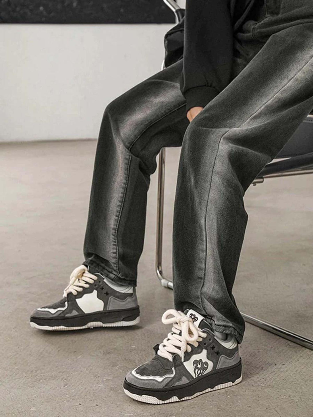 Casual look with TALISHKO sneakers and dark jeans, showcasing monochrome street style.