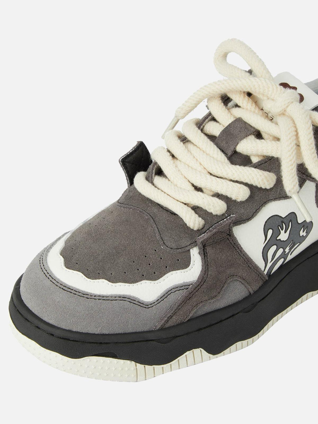Intricate look at TALISHKO sneakers' flame design and textured suede with bold laces.