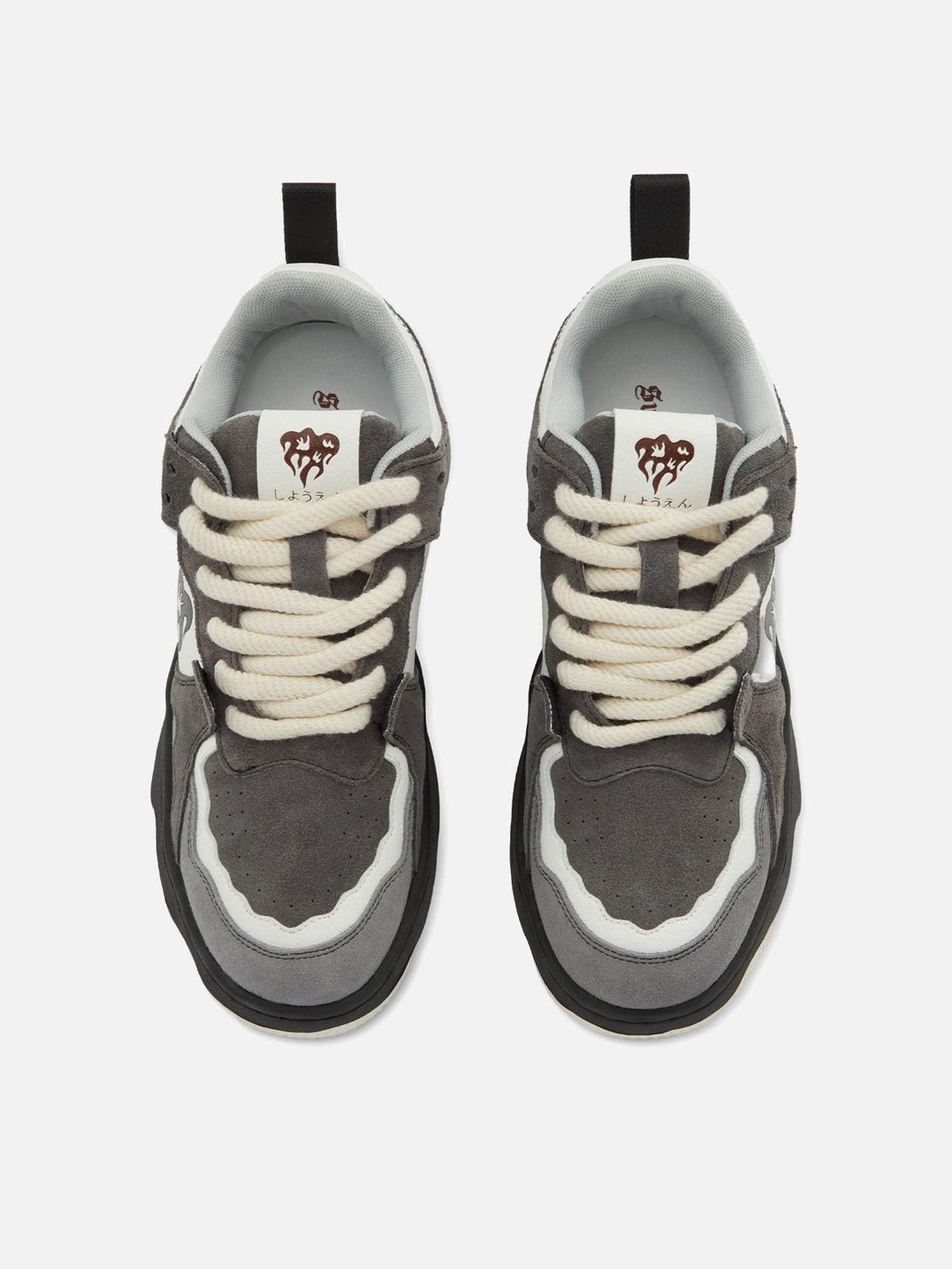 Top view of TALISHKO sneakers featuring a monochrome design and thick, bold laces.