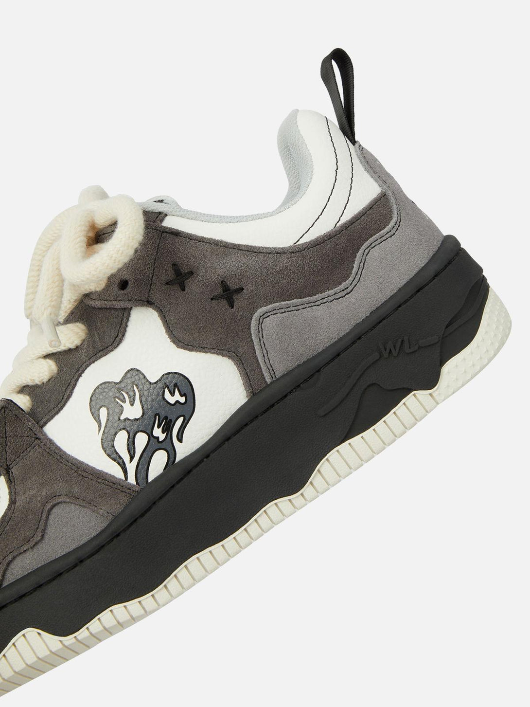 Close-up of TALISHKO sneaker showcasing flame detail and chunky sole design.