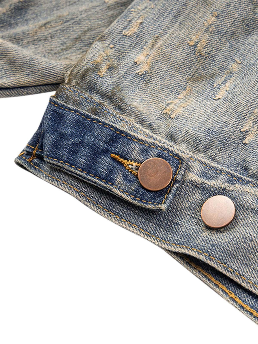 Detailed look at the mud-dyed distressed denim with copper buttons by TALISHKO.
