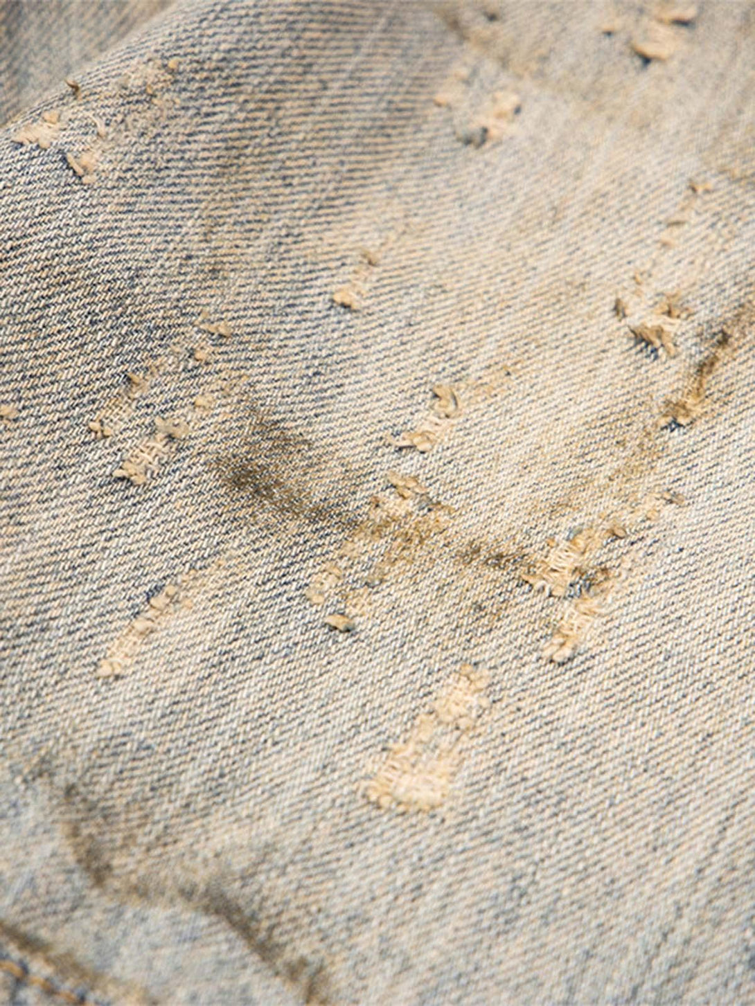 Texture and pattern showcased on mud-dyed distressed denim by TALISHKO.