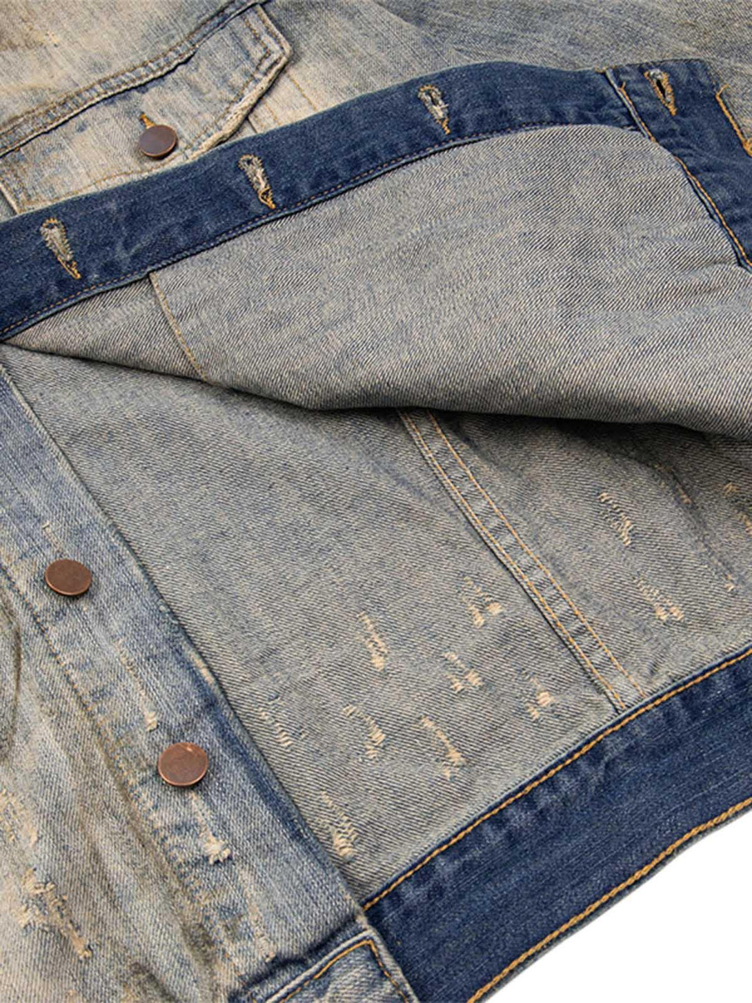 Intricate detailing of the mud-dyed distressed denim jacket by TALISHKO, featuring copper buttons.