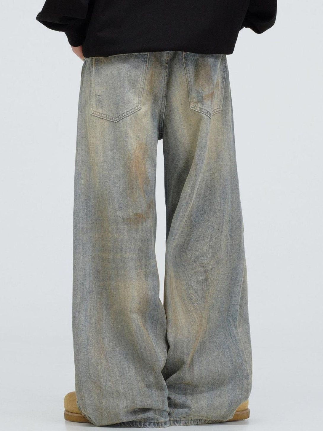 Back view of TALISHKO jeans highlighting relaxed fit and distressed vintage fade.