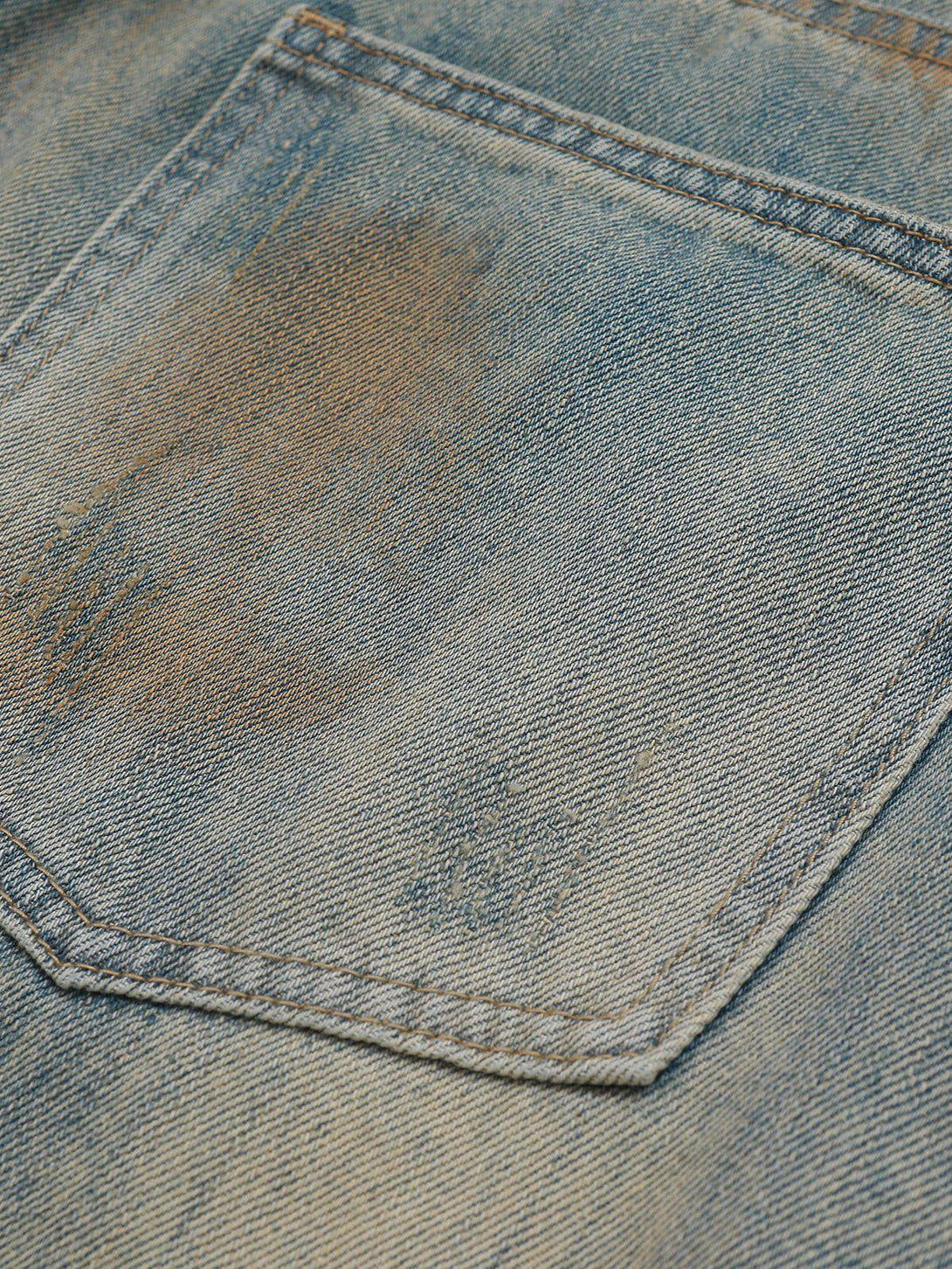 Detailed fabric and stitching on TALISHKO jeans with distressed vintage fade and mud dyeing.