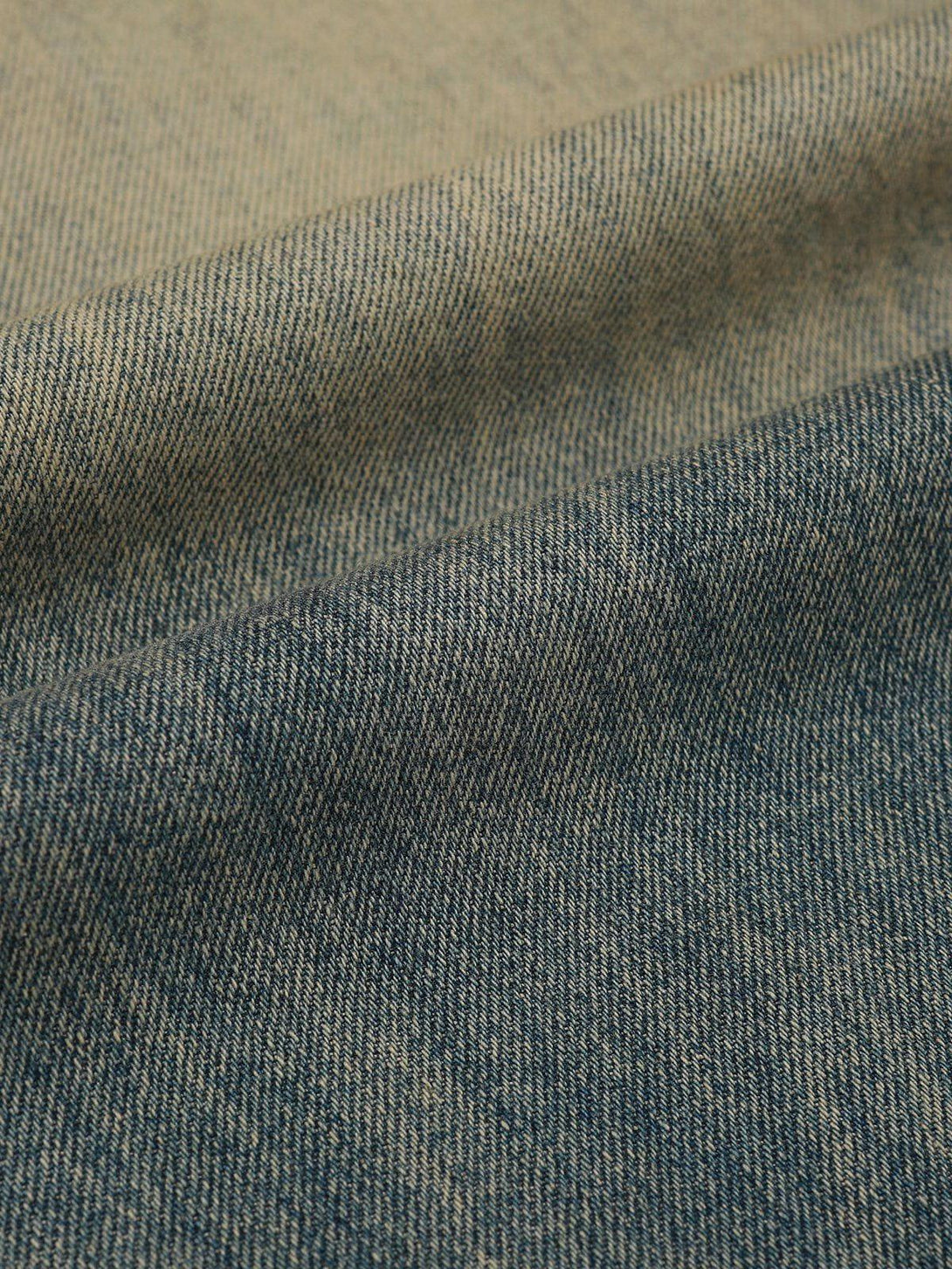 A textured view of mud dyeing jeans fabric by TALISHKO, highlighting its unique weave.
