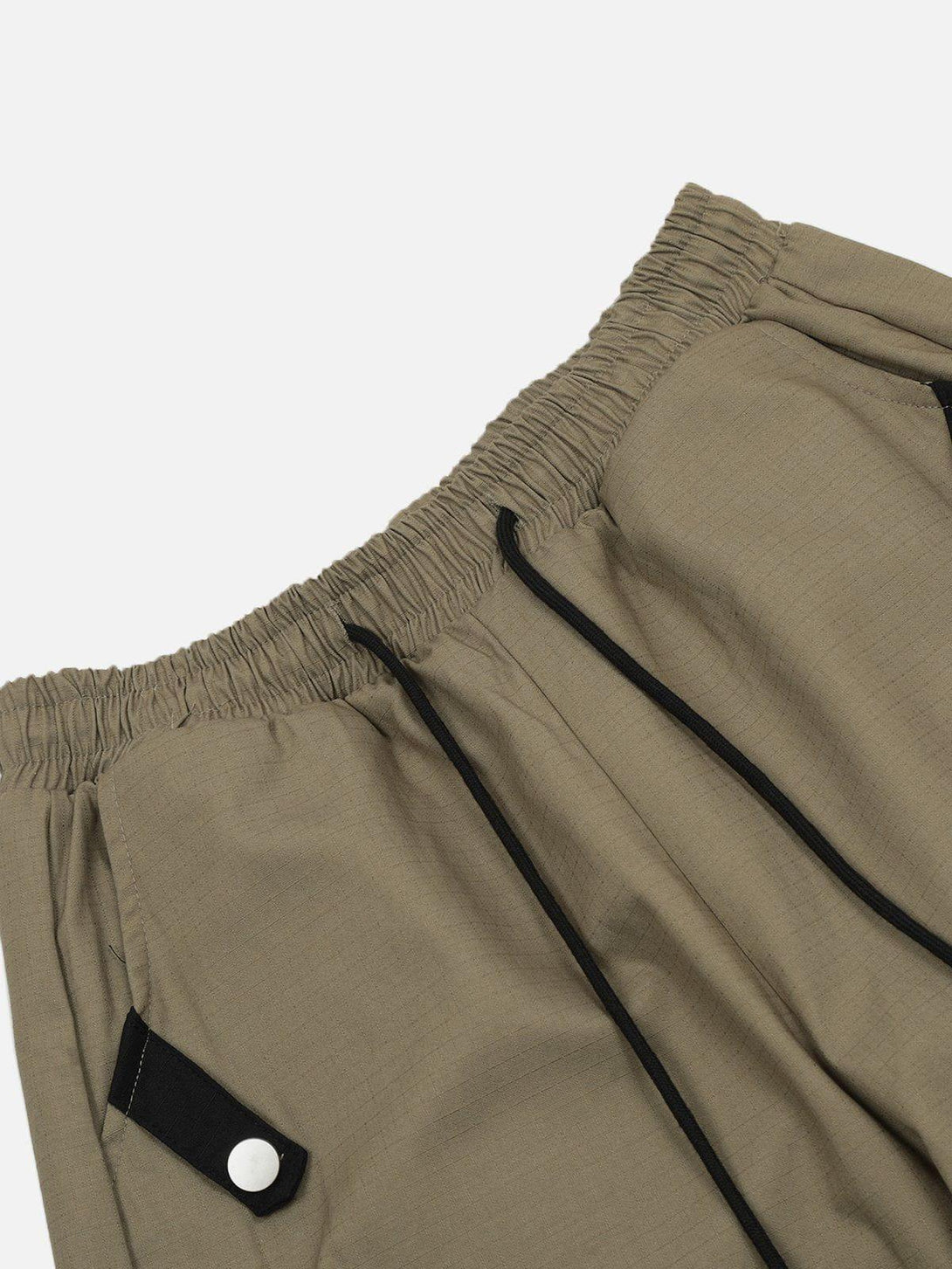 Elastic waistband and pocket detail of TALISHKO cargo pants, highlighting versatile style.