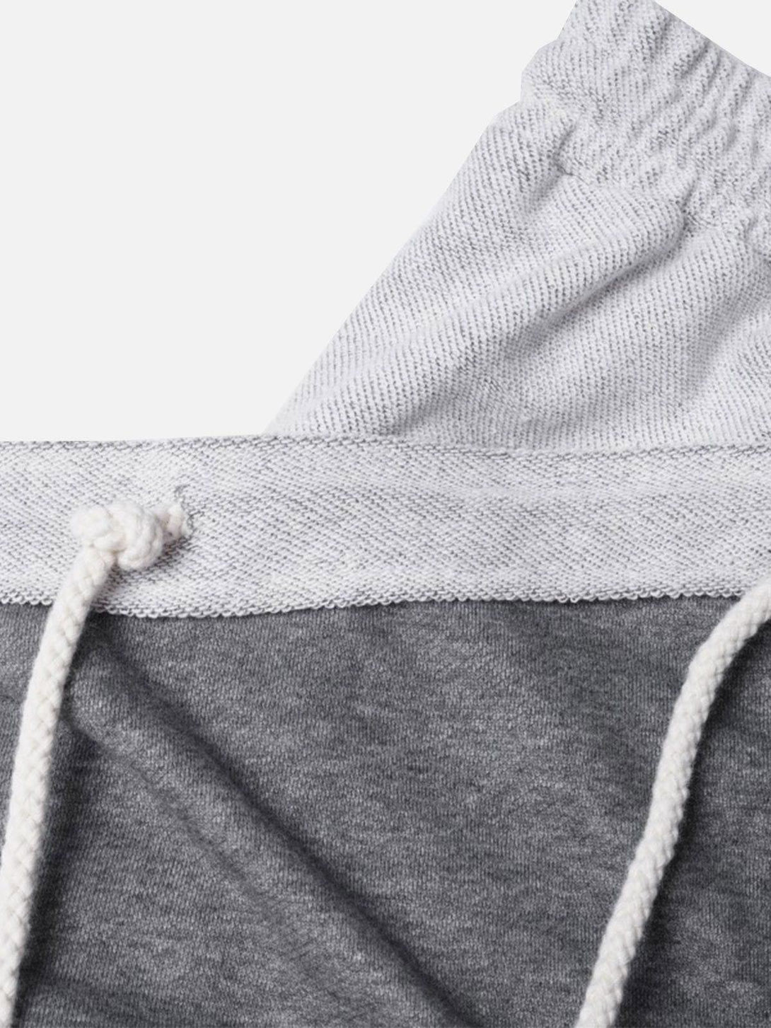 A detailed look at TALISHKO's gray multi drawstring shorts, showcasing the elastic waistband.
