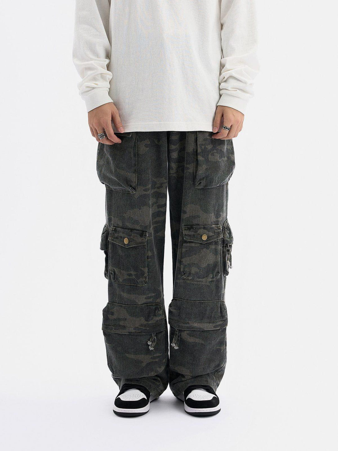 Model wearing TALISHKO multi-pocket camouflage cargo pants, showcasing a relaxed streetwear vibe.