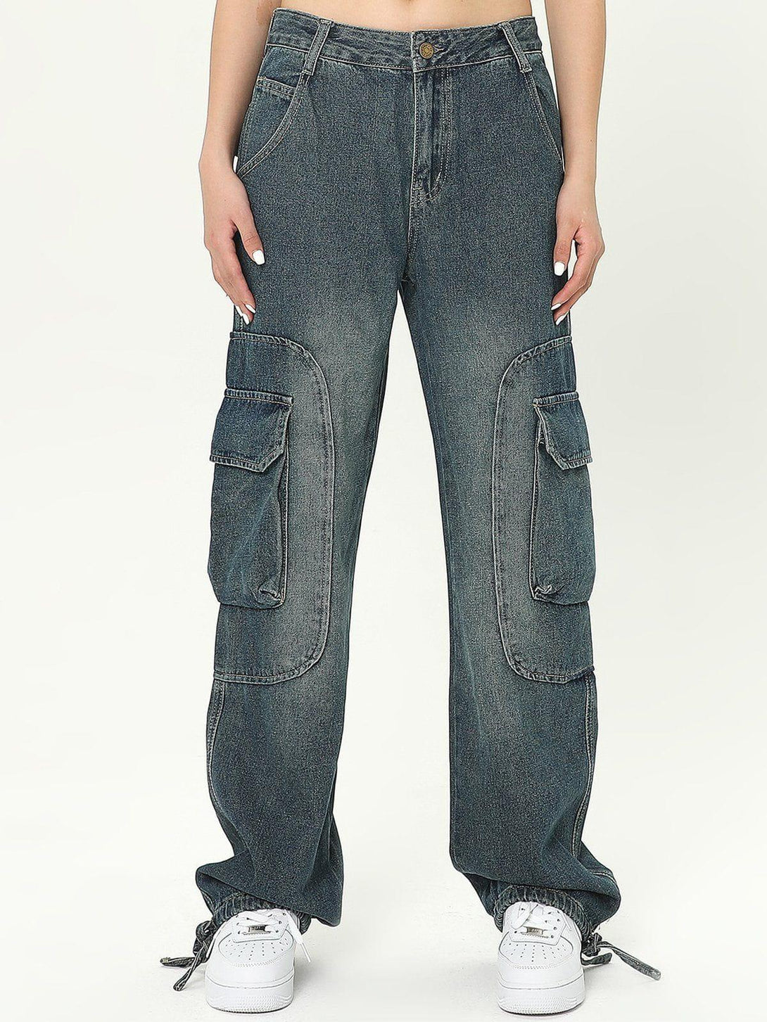Casually styled multi-pocket cargo jeans by TALISHKO, showcasing a front view with sneakers.