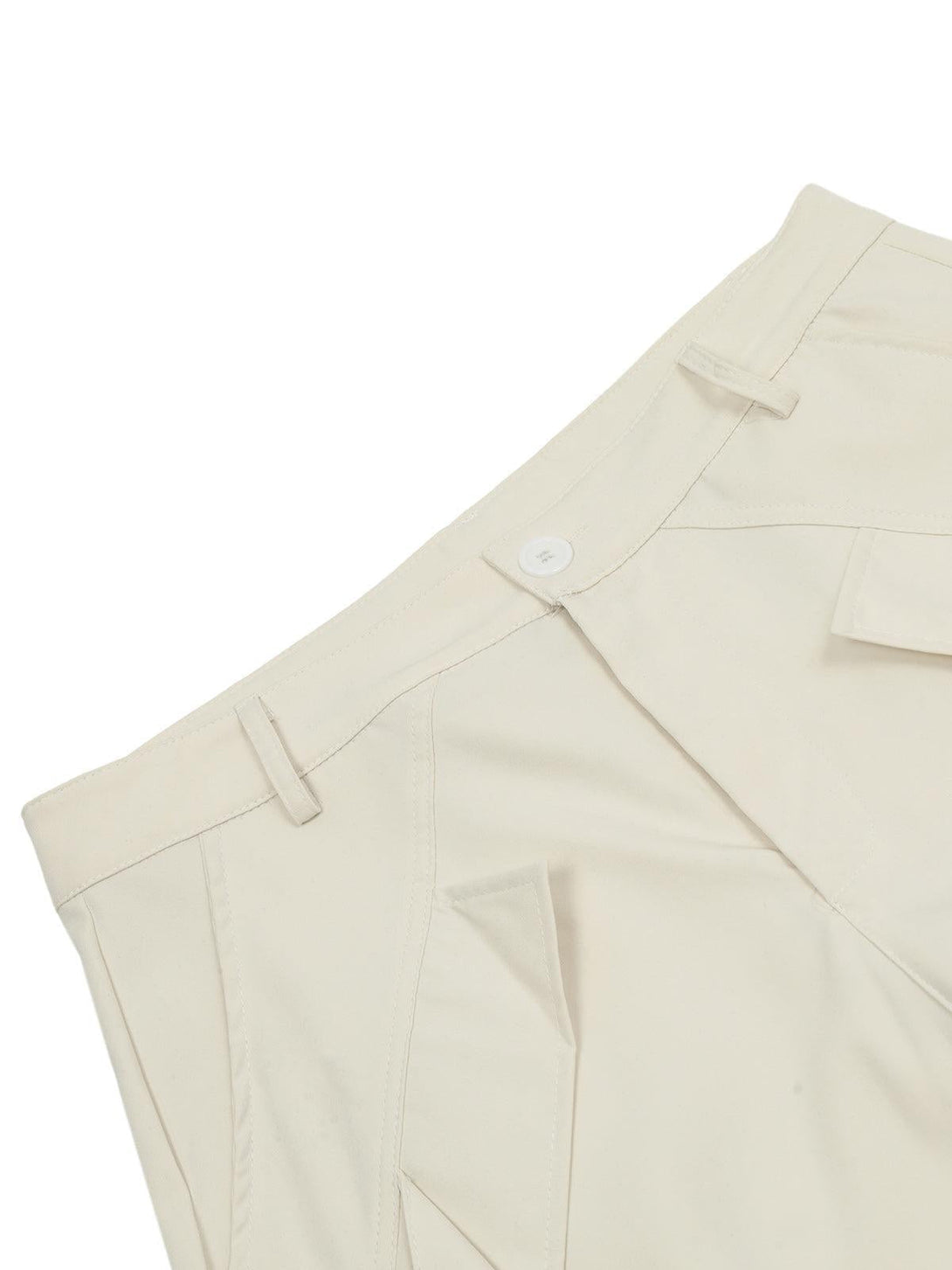 Detailed fabric and stitching of beige cargo pants by TALISHKO, highlighting pocket design.