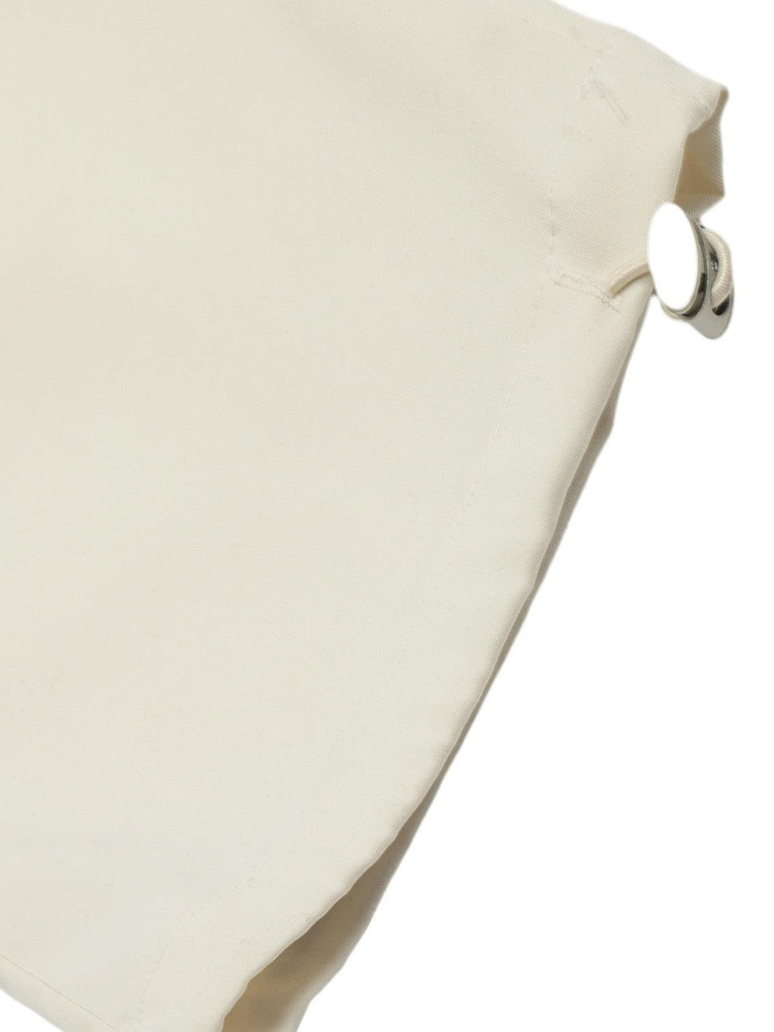 Close-up of beige fabric and buckle detail on TALISHKO cargo pants, emphasizing craftsmanship.