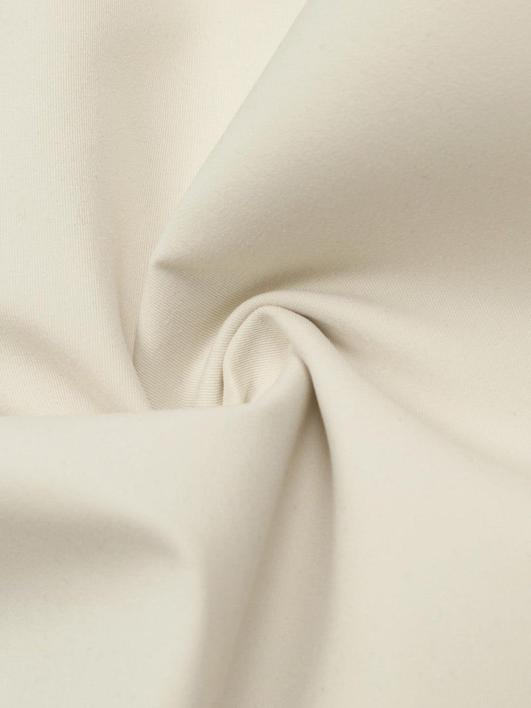 Zoomed-in texture of beige fabric on TALISHKO cargo pants, highlighting quality craftsmanship.