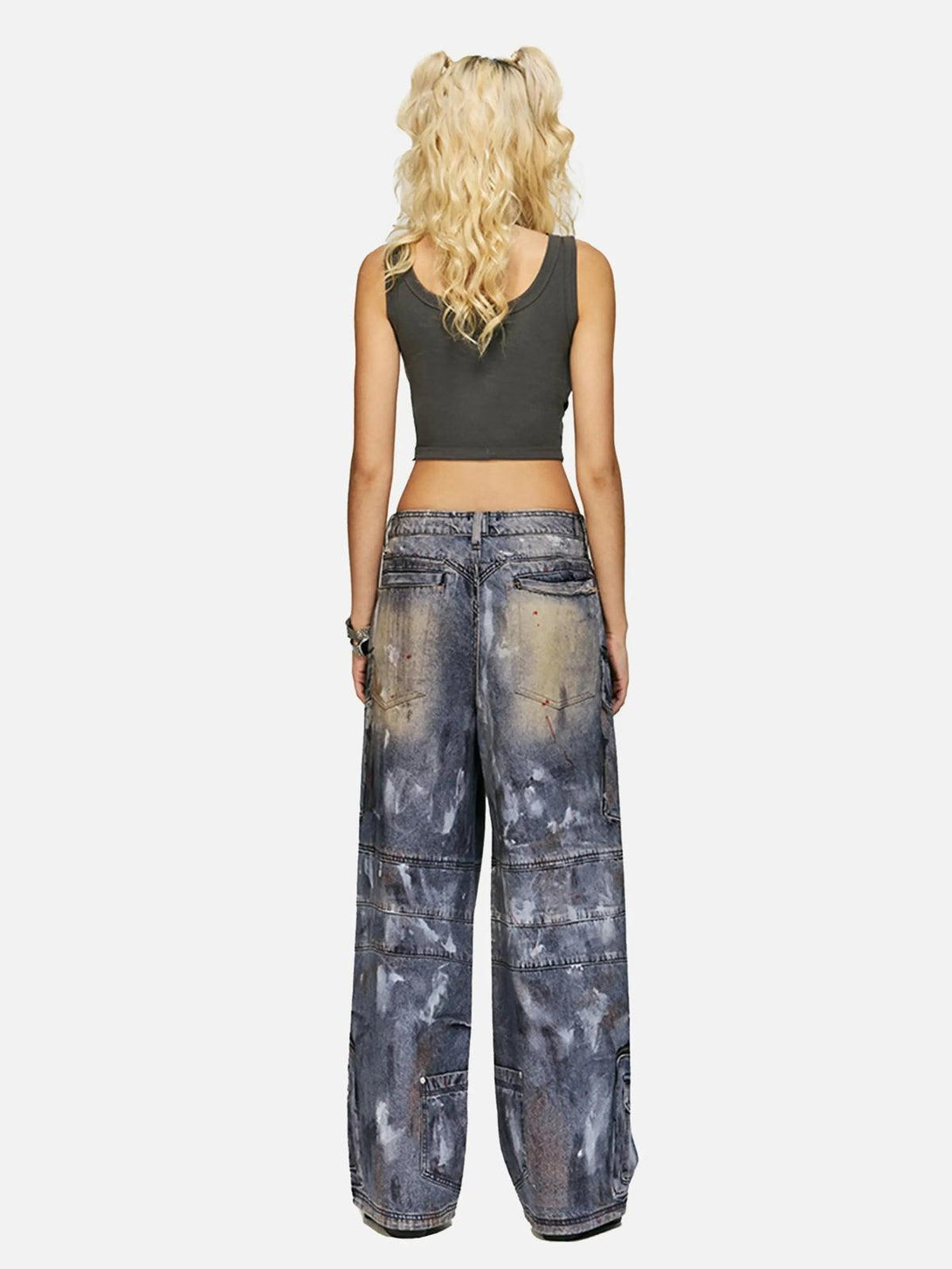 Back view of TALISHKO multi-pocket dirty overalls jeans paired with a dark cropped tank top.