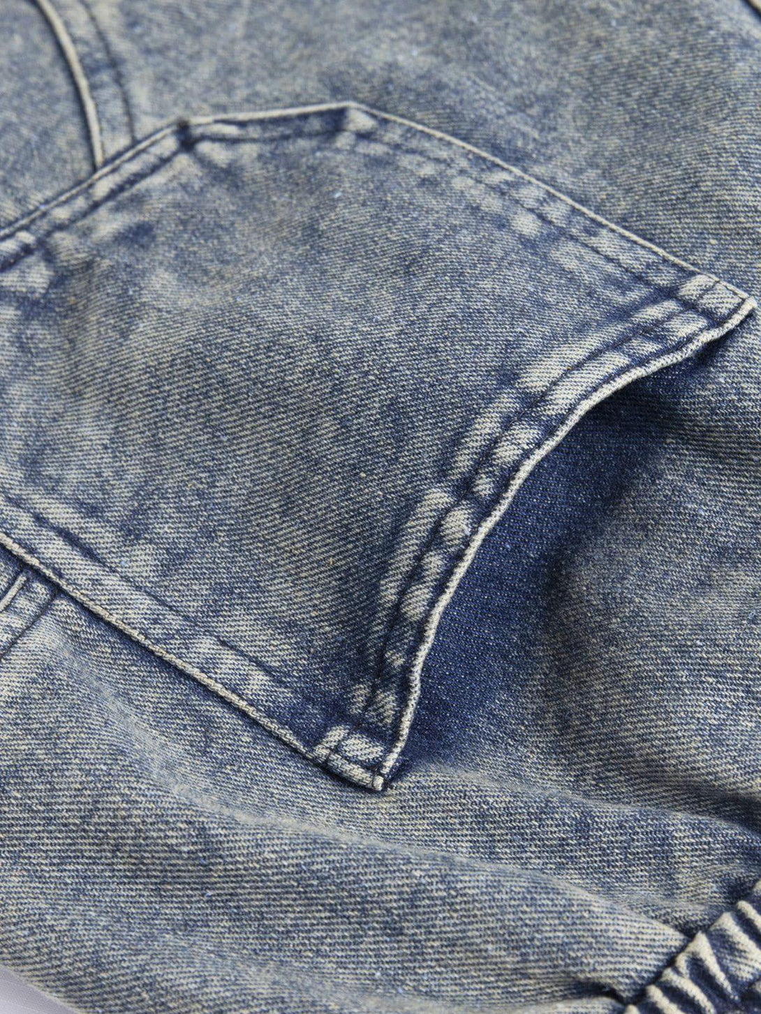Detailed stitching on TALISHKO's multi-pocket drawstring jorts, capturing casual denim style.