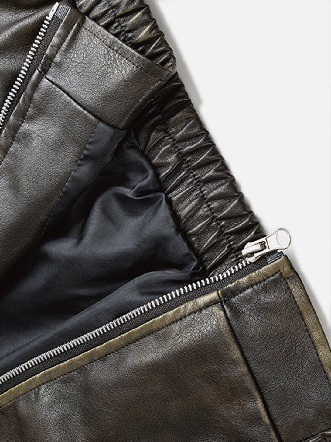 A detailed look at the TALISHKO faux leather jacket's zipper and lining, showcasing craftsmanship.