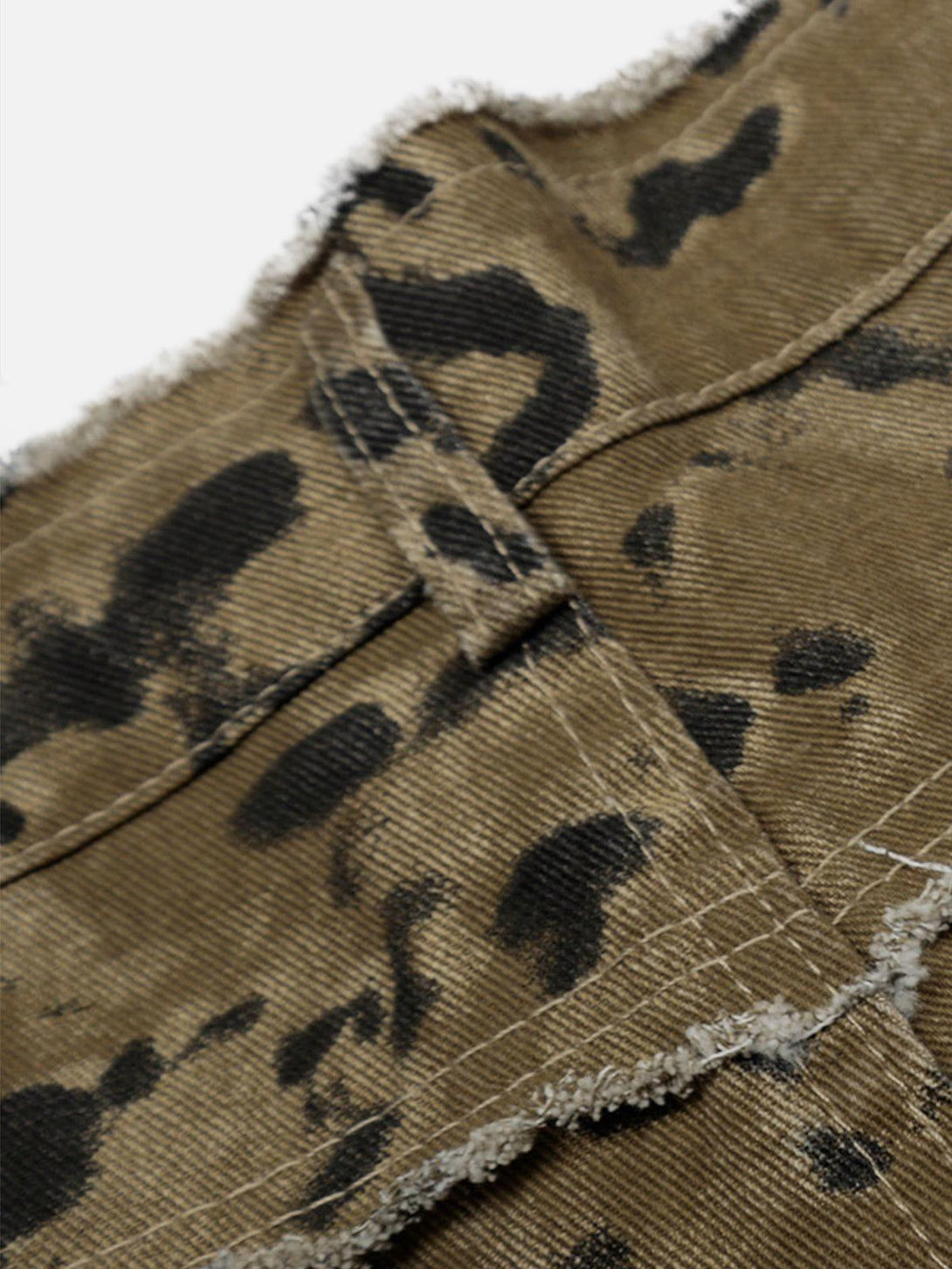 Intricate look at TALISHKO jorts' texture and pattern, featuring fringe details and unique design.