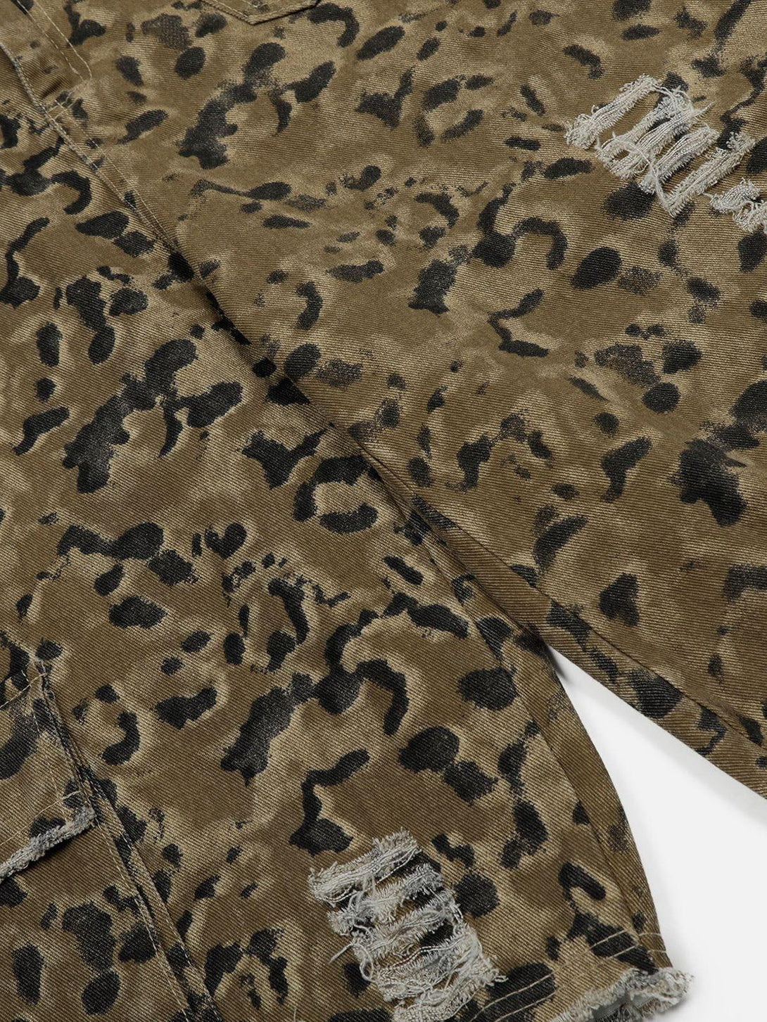 Detailed fabric and fringe texture of TALISHKO longline jorts with a unique pattern design.