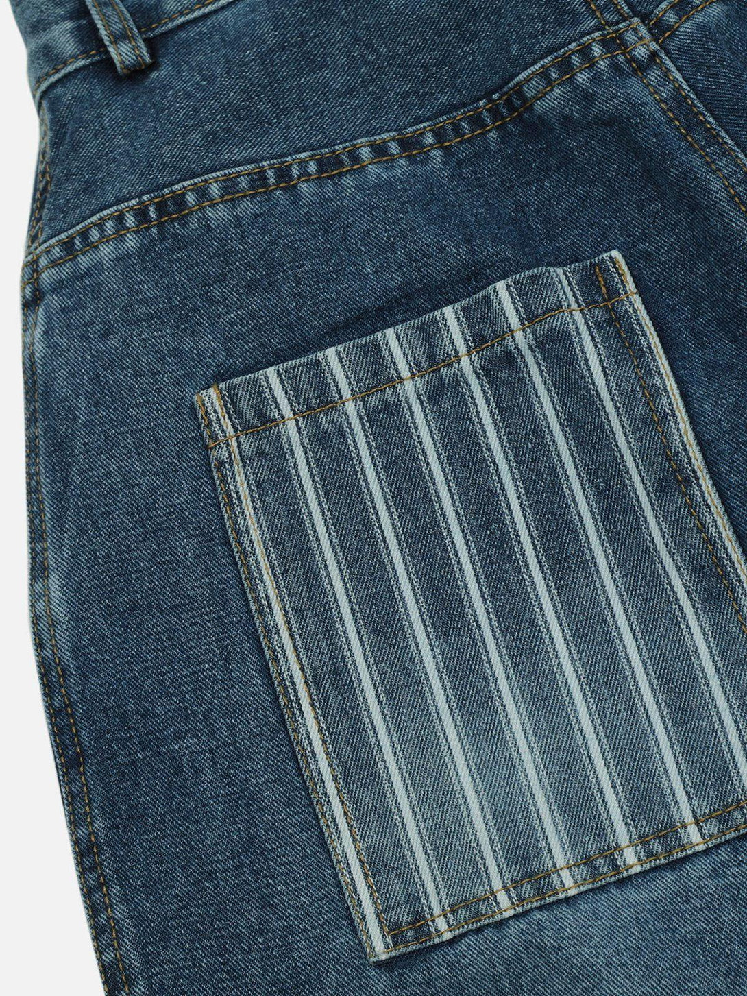 Close-up of TALISHKO jeans highlighting striped multi-pocket detail on blue denim.