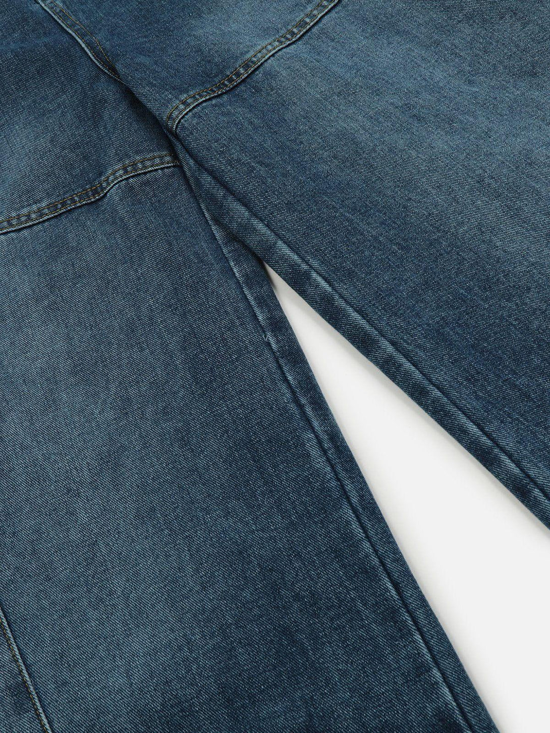 Detailed view of TALISHKO jeans showcasing the rich denim texture and multi-pocket stitching.