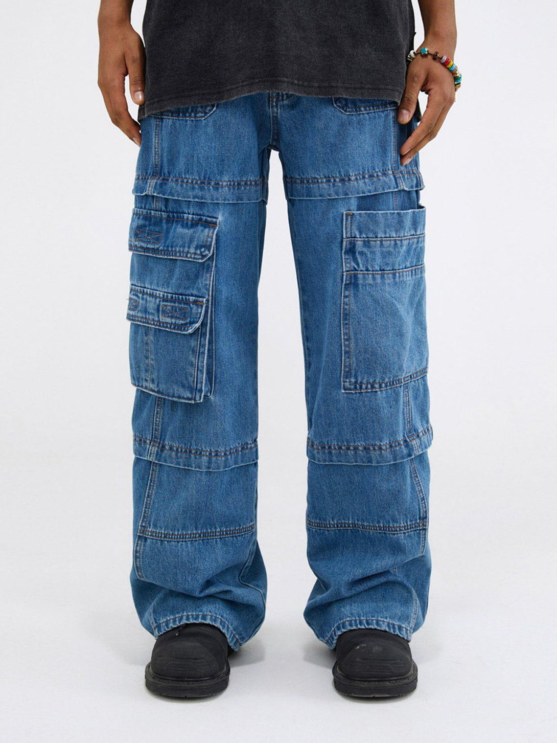 TALISHKO straight-leg jeans featuring patchwork design and multiple pockets, styled casually.