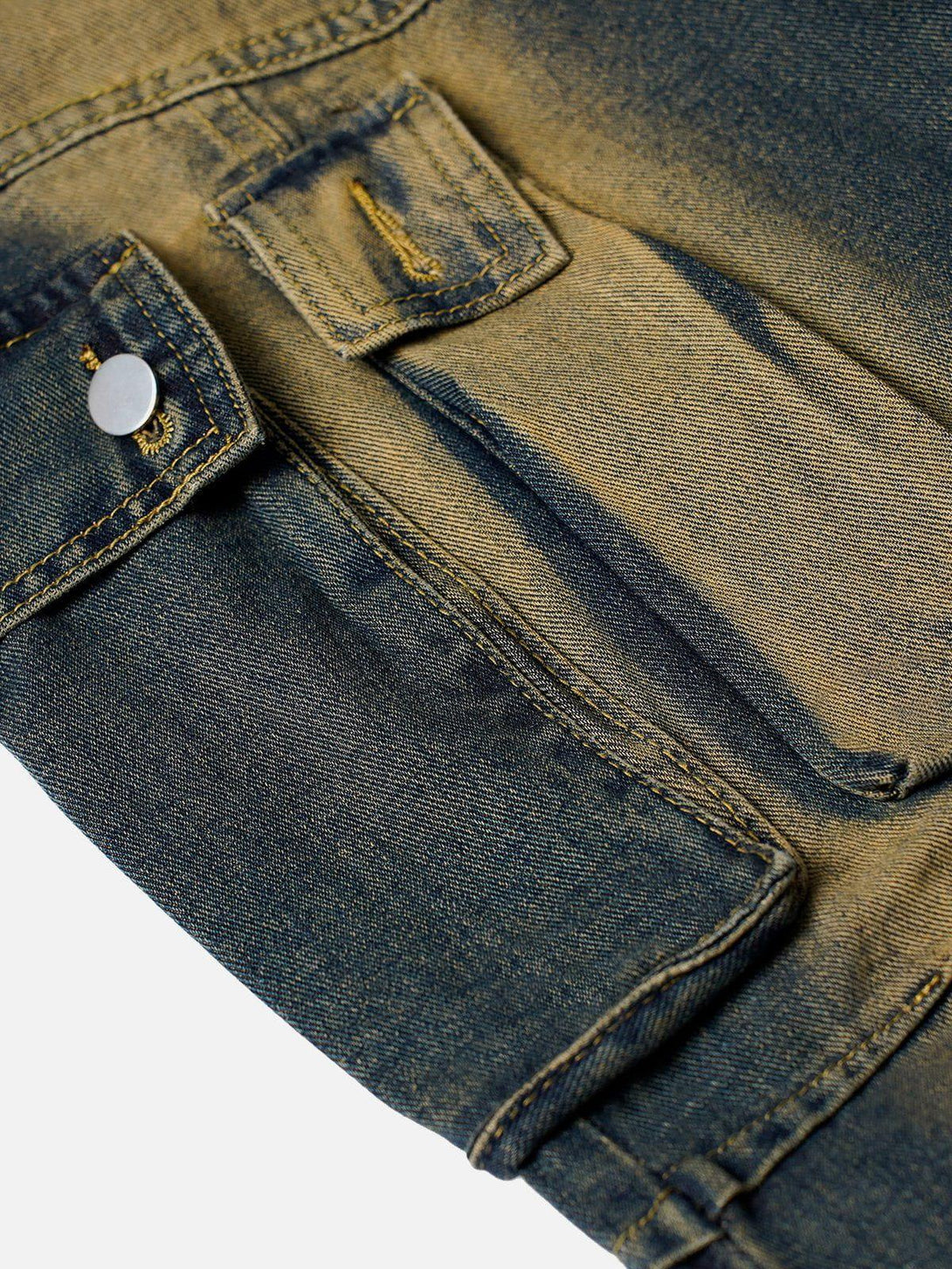Focusing on the detailed stitching and washed texture of TALISHKO cargo jeans pockets.