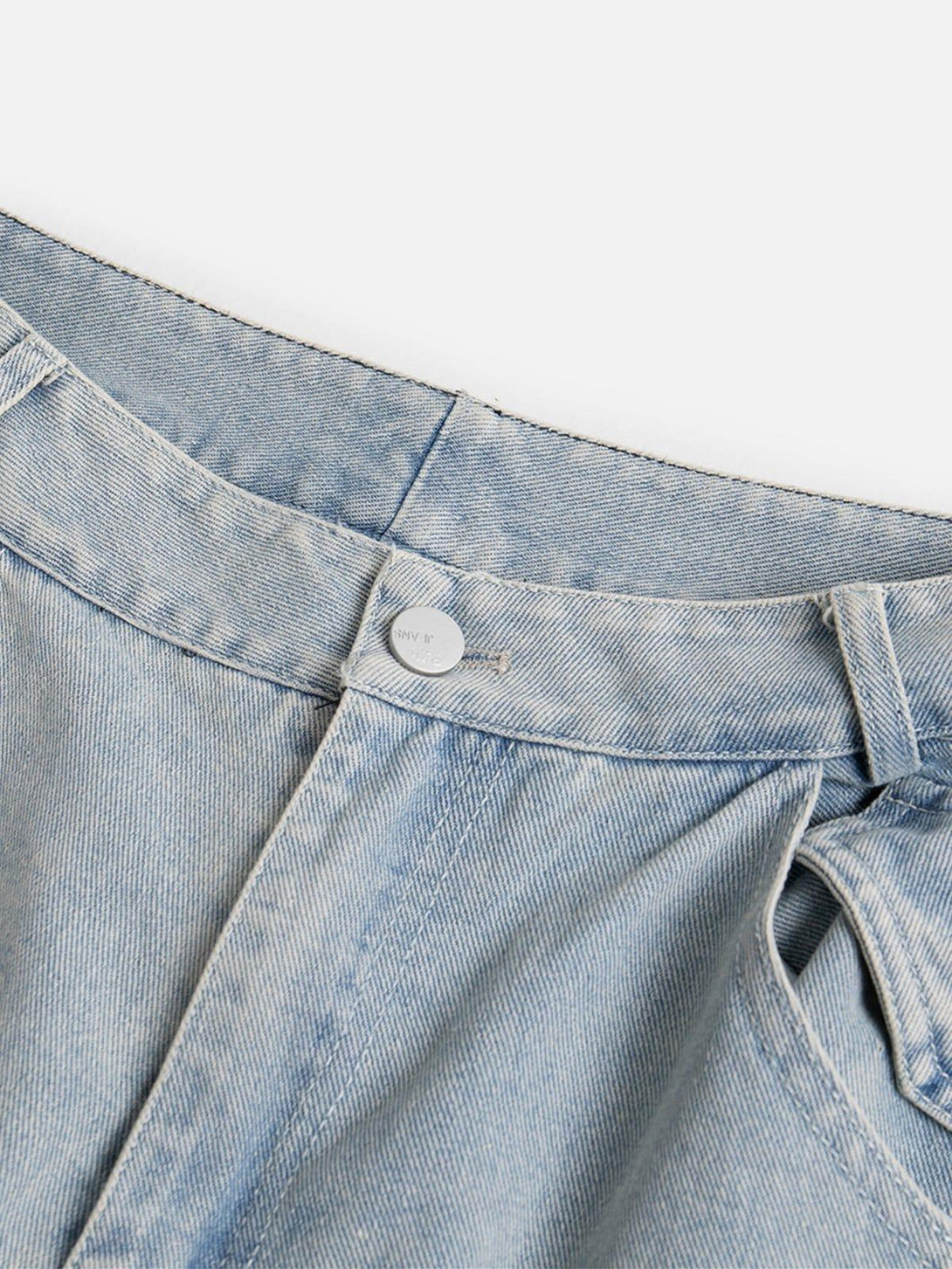 A detailed look at TALISHKO multi-pocket washed jeans, highlighting the button and fabric texture.