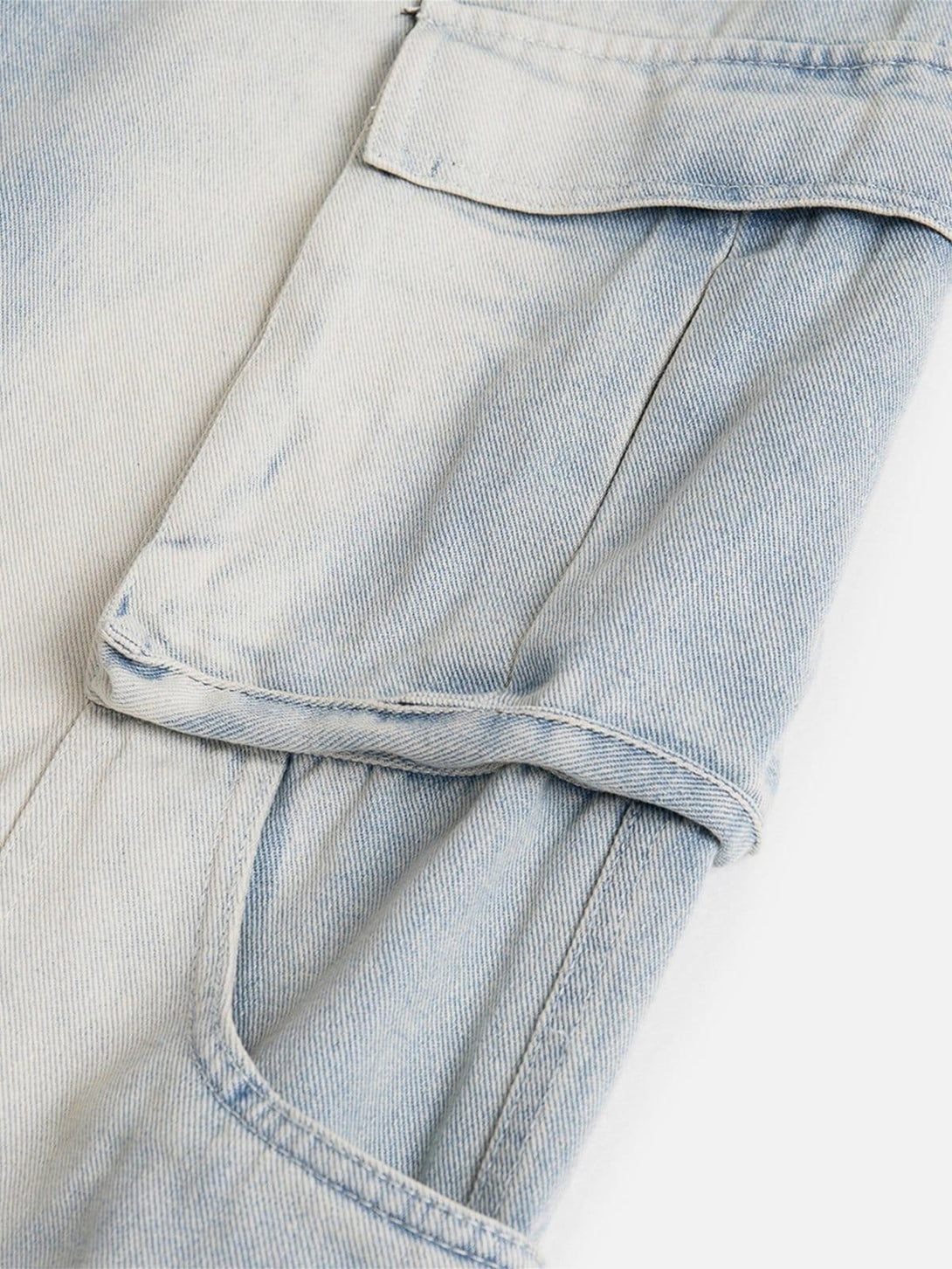 A close-up of TALISHKO multi-pocket washed jeans, highlighting detailed stitching and pockets.