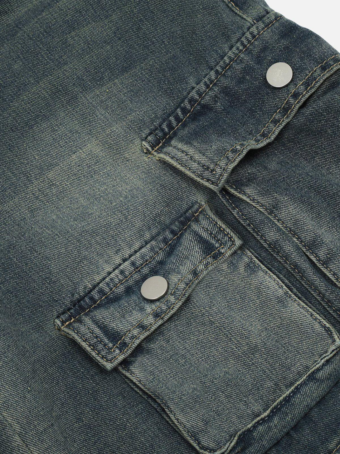 Detailed fabric and stitching of TALISHKO multi-pocket washed jorts, highlighting rugged denim style.