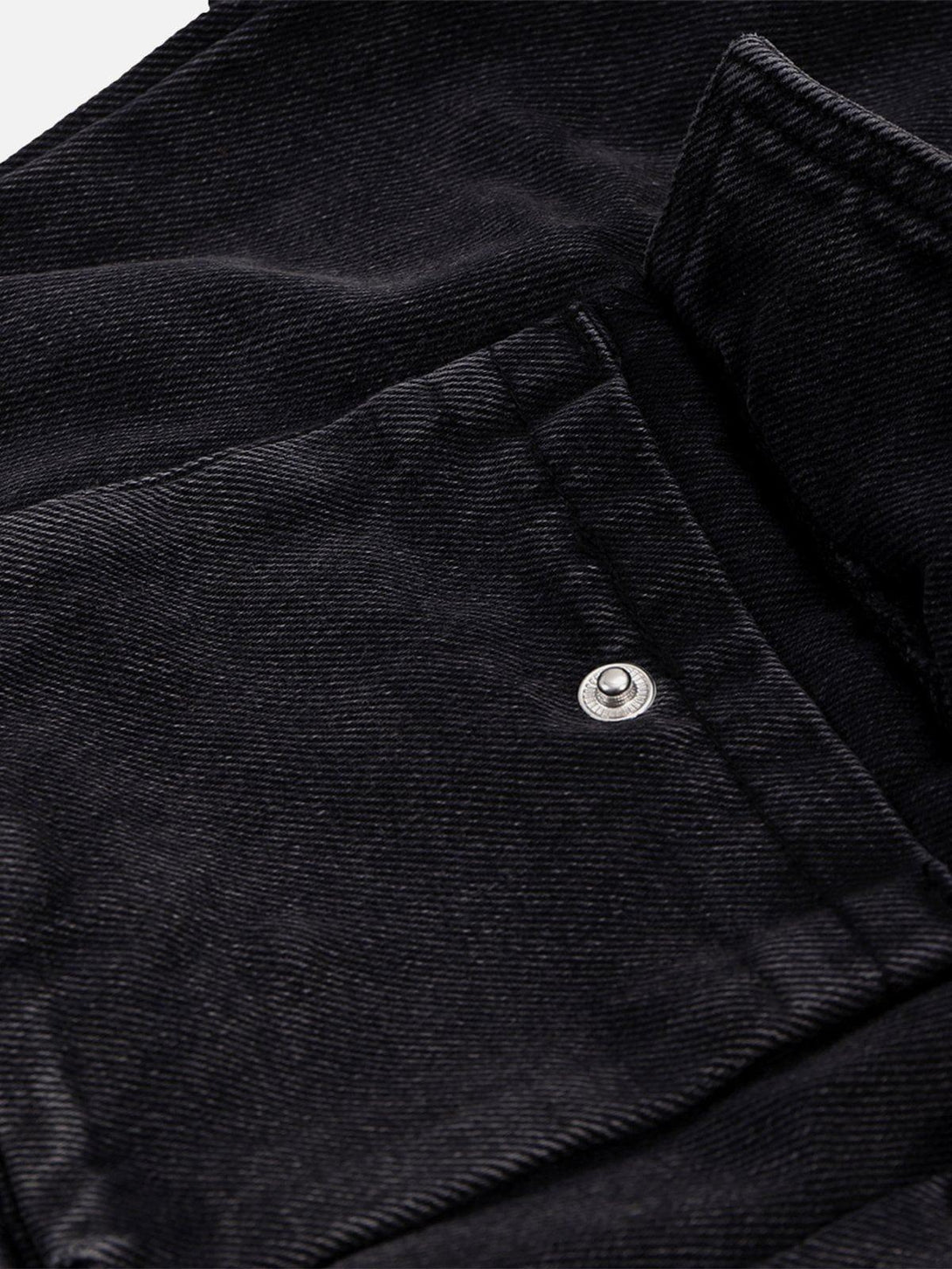 A detailed look at the black fabric and pocket design of wide-leg jeans by TALISHKO.