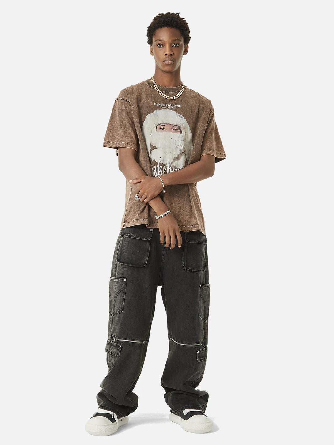 Model wearing TALISHKO multi-pocket hip-hop jeans with a graphic tee and sneakers.