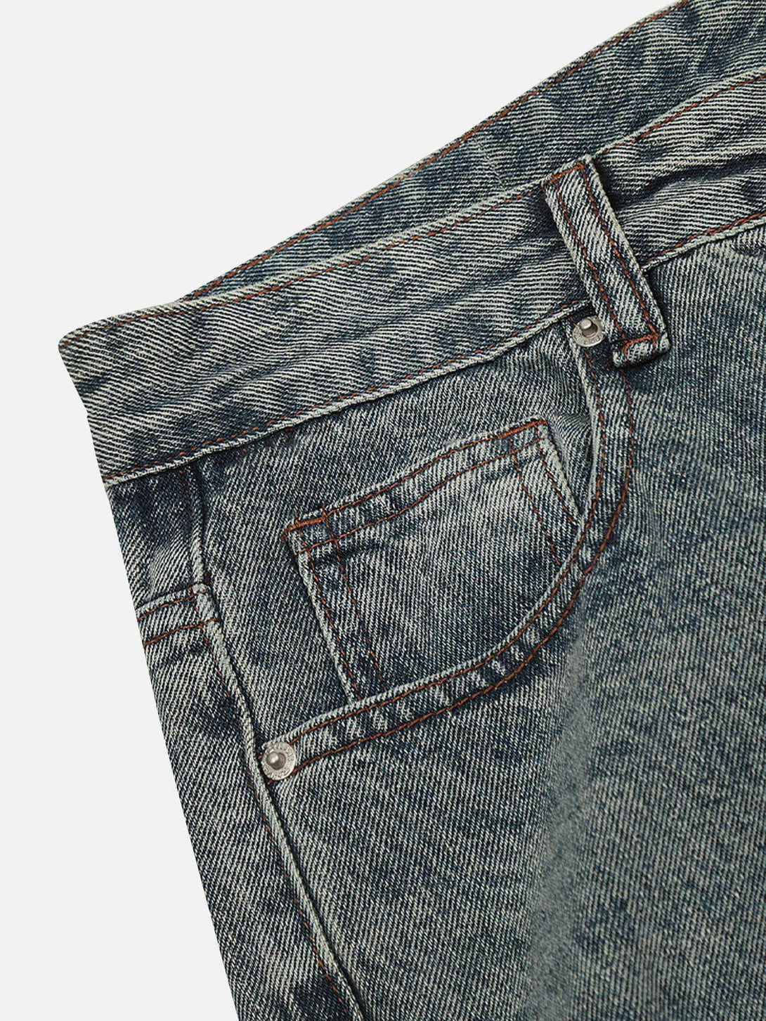 Detailed fabric and stitching of wrinkle-washed jeans, featuring a classic look by TALISHKO.