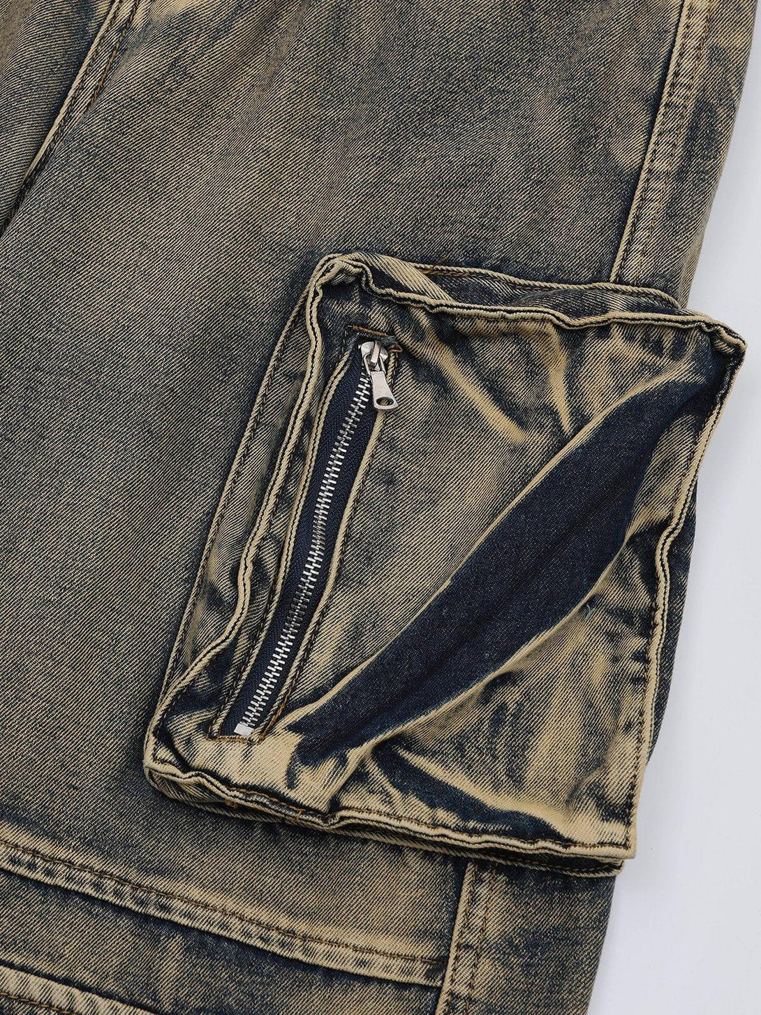 A detailed view of TALISHKO's washed jeans pocket, highlighting the unique wash and texture.