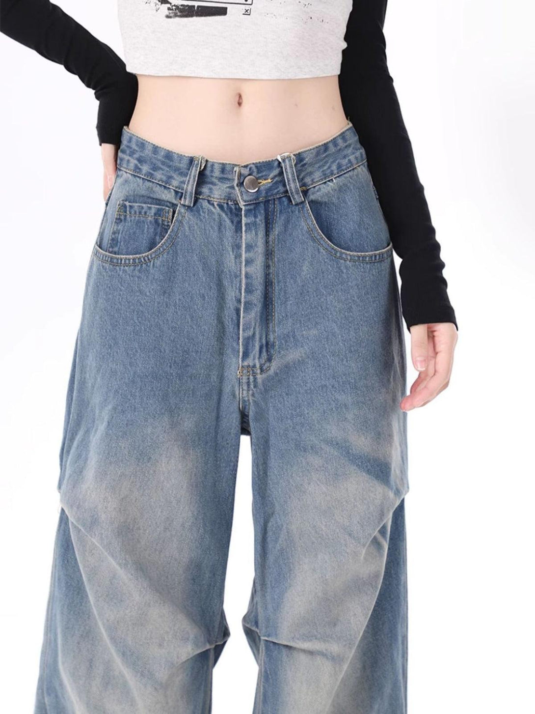 Model wearing TALISHKO's stylish wrinkle jeans, highlighting a relaxed and trendy fit.