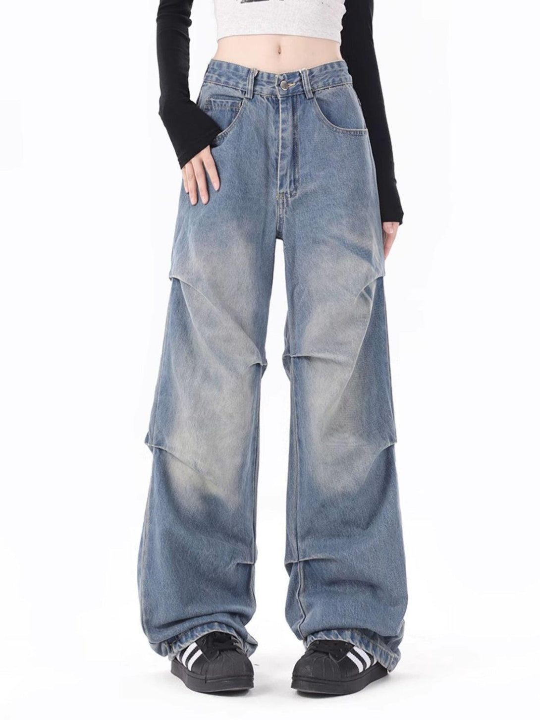 TALISHKO wide-leg jeans with distinctive wrinkle design, modeled with a trendy streetwear style.
