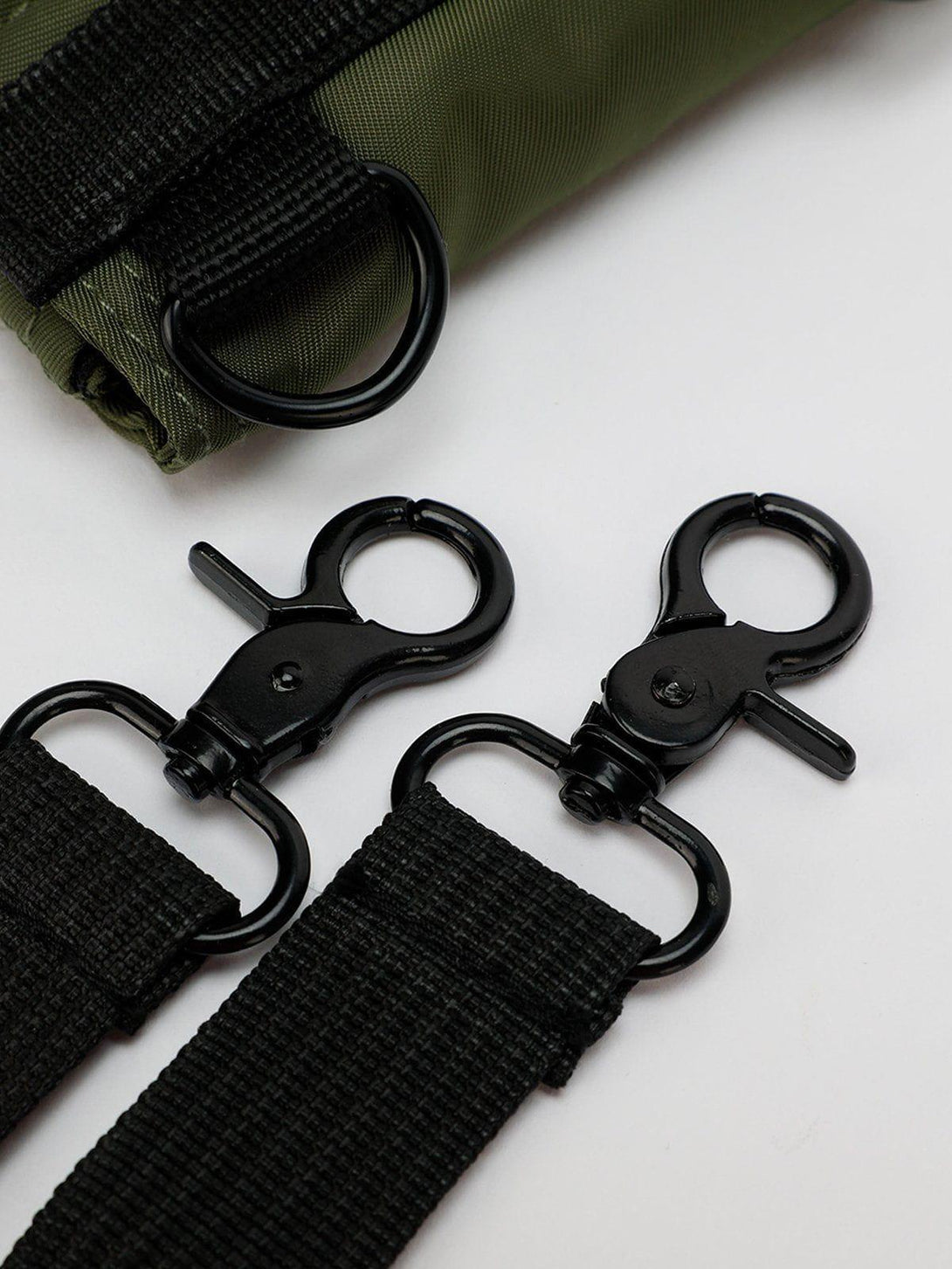 Detailed view of TALISHKO's multipurpose bag, focusing on black hardware and strap design.